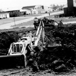 00-00-0000 Backhoe and tractor sitting in pile of dirt. Photo by Robert Mills