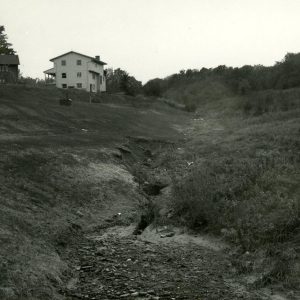 00-00-0000 Eroded waterway beside some houses-website