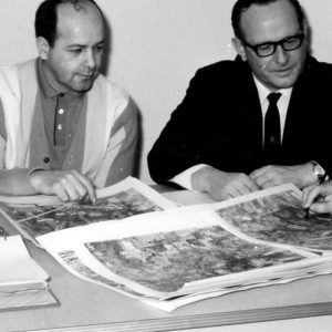 00-00-0000 Four men sitting at table looking at charts. Photo by Robert Mills