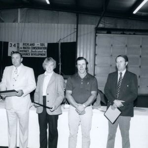 00-00-0000 Group of 4 men & 1 woman standing with awards in hands-website