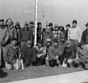 00-00-0000 Large group of men sitting around a flood gage. Photo by Robert Mills