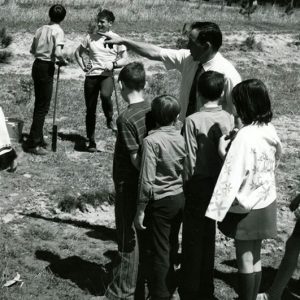 00-00-0000 Man directing group of children , apparently planting trees-website