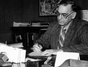 00-00-0000 Man signing document. Photo by Robert Mills