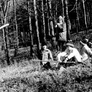 00-00-0000 Man with hatchet talks to small group sitting on ground. Photo by Robert Mills