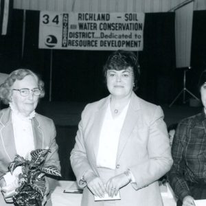 00-00-0000 Three women at Annual Meeting. (Looks like Dick Forbes in backgroundd)-website