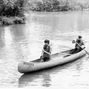 00-00-0000 Two boys in canoe. Photo by Robert Mills