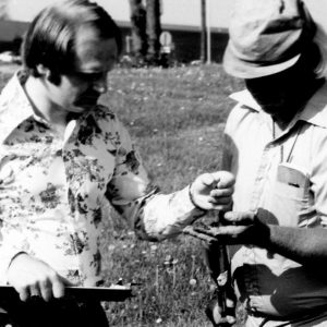 00-00-0000 Two men in field,with chart and an instrument. Photo by Robert Mills