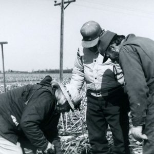 00-00-0000Three men, one with a tool-website