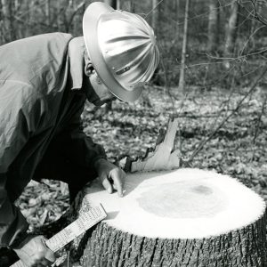 03-06-1973 Norris Quam,SCS Woodland Conservationist examines a white oak stump 150 years old. Edward Arnold Farm-website