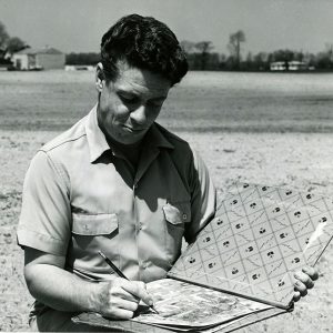 05-06-1964 Soil Scientist C.Edward Redmond plots soil boundaries on an aerial photo after examining soil-website