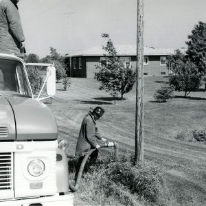 06-08-1973 Leslie Carr,Marvin Galloway of the Franklin volunteer Fire Dept as they fill their tanker at the Doyle McCarron Farm pond-website