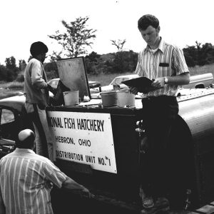 07-07-1972 Dorian McKinney (on rt.) distributes Large Mouth Black Bass previoulsy ordered for farm ponds-website