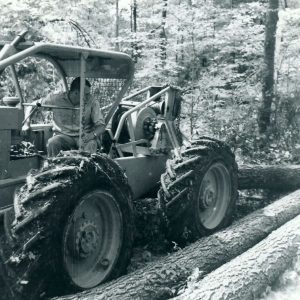 07-13-1964 Man in tractor picking up log-website