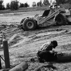 07-17-1965 Jim Bricker at Ralph Close Farm. Welding the outlet pipe for a new pond-website