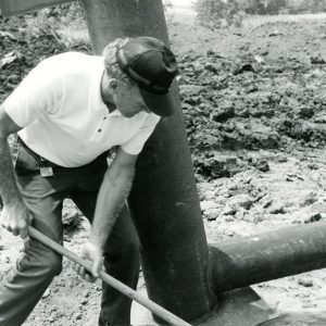 07-17-1975 George Smith preparing pipe for placement at the Bill Evans Farm-website