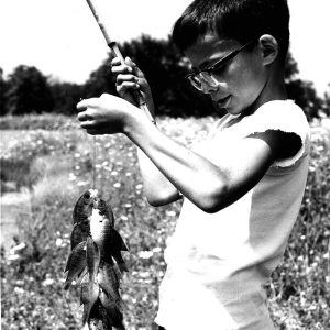 07-28-1957 Tom Mills(age 8) string of bluegill caught with worms on cane pole at L. Volk pond Chatfield)-website