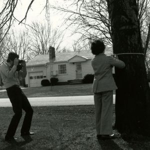 08-12-1979 Exec.Sec.Van Loon taking picture of Secretary M. Matteson measuring a tree for the Big Tree Contest-website