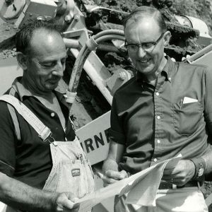 09-29-1971 John Scherer Farm. Frank Ebert & Dean Swigart examine the engineering plans for pond at the John Scherer Farm near Shelby-website