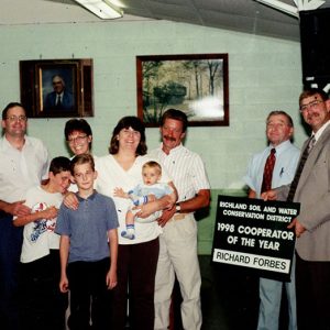 1998 Cooperator of Year. Back L to R Larry, Barb,Patty, Gary, Richard Forbes,Ken Burrer. Front Robert,William, Thomas-website