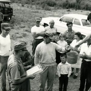 Receiving fish at Bellville are Avery Adams,his son, and father Roger Adams with others looking on-website