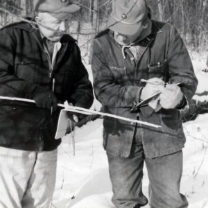 Two Men Taking a Measurement in Forest in Winter (photo by Robert Mills)