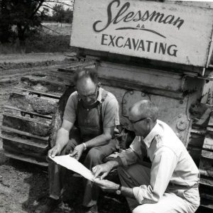 Two men examining plans in front of excavator-0001