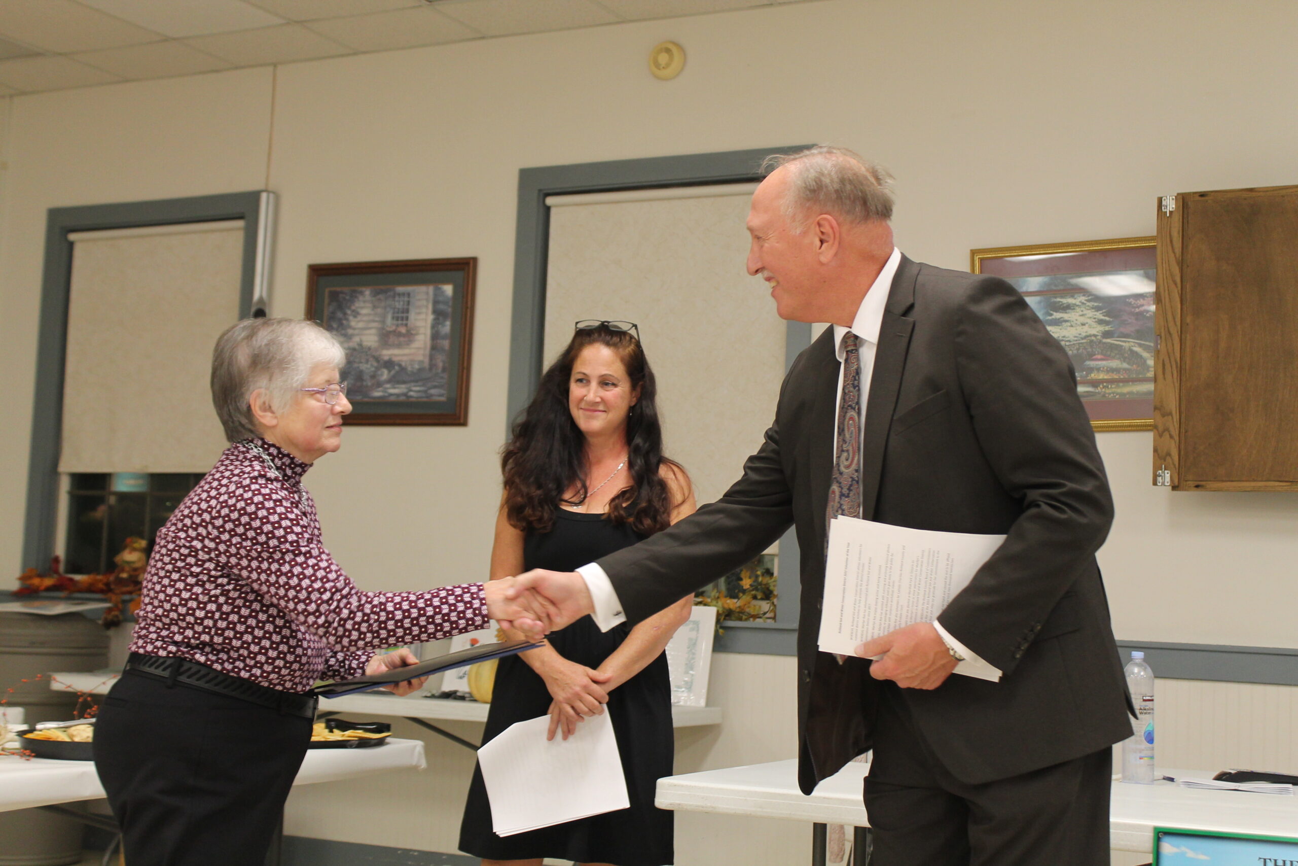 Roe, Marilyn Vol of Year being presented proclamation by Rich Cty Commissioner Mears, Cliff