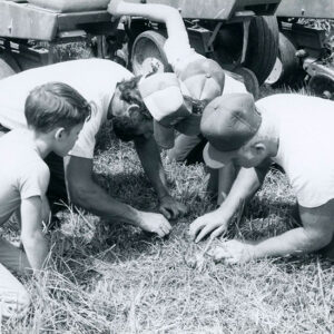 00_00_0000_3_Men_and_a_boy_examining_soil._Planter_equipment_nearby_website-5266