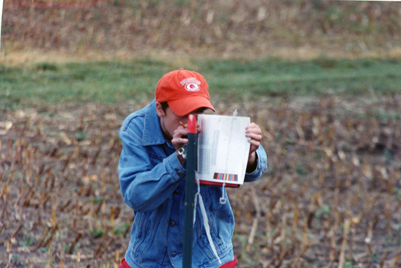 Student checking slope of land
E491