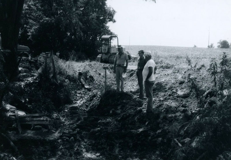 S. Swigart discussing outlet location with contractor on the Owens' waterway
Photo ID#: A1003