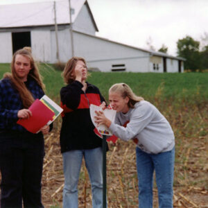 00_00_0000_Girl_checking_slope_of_land_while_two_other_girls_stand_by_with_folders_Website-5606