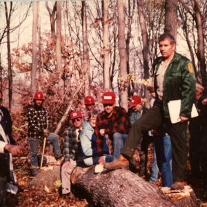 00_00_0000_Group_of_men_standing_around_a_felled_tree_in_forest_website-3887
