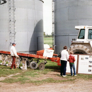00_00_0000_Man__Woman___boy_looking_at_equipment_display_and_poster_display_in_front_of_silos_Website-5578