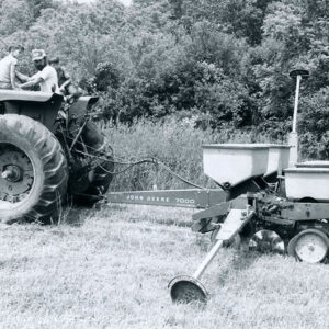 00_00_0000_Man___two_boys_on_a_tractor_pulling_a_seeder_through_field_website-551