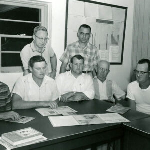 00_00_0000_Seven_men_at_table_examining_documents_2_Website-5809