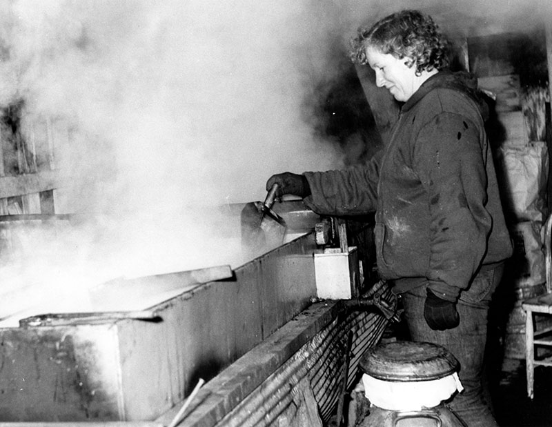 March 2, 1974
Mrs. Howard Isley shown in the Isley sugar house as she skims boiling sap
Photo ID#: A522
