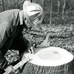 03_06_1973_Norris_Quam_SCS_Woodland_Conservationist_examines_a_white_oak_stump_150_years_old._Edward_Arnold_Farm_website-3812
