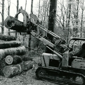 03_20_1969__Ronnie_Dunn_of_Brenemen_Brothers_Lumber_Co._Piling_logs_at_the_Wayne_Stewart_24_acre_tract_of_timber_1_website-3814