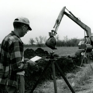 04_30_1975_Don_Shauch_shown_as_he_checked_the_grid_for_contractor_Doug_Smith_who_constructed_the_new_open_ditch_website-498