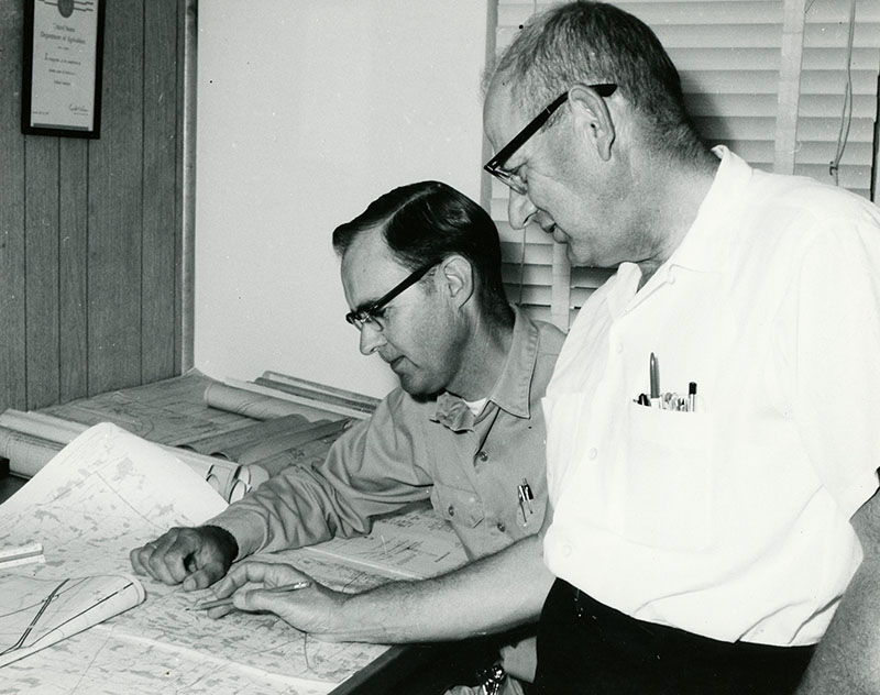 June 25, 1969
Dean Swigart and Carroll Dunfrey (ODNR) are shown as they check drainage outlet needs for the new route 30
Photo ID#: PL210