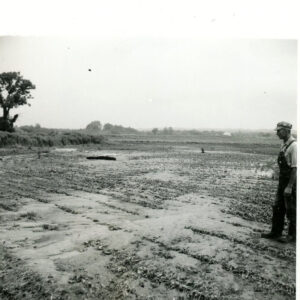 07_05_1969_John_Winger_observing_damage_to_his_soybean_field_by_silt___gravel_deposited_by_July_4th_flood._Richland_County__Mifflin_Twp_Sec_5___8_website-525