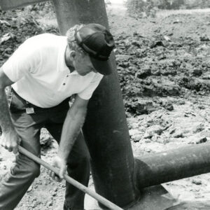07_17_1975_George_Smith_preparing_pipe_for_placement_at_the_Bill_Evans_Farm_website-4026