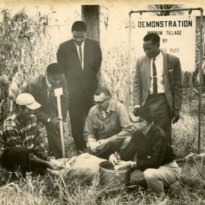 10_28_1964_African_visitors_help_check_corn_test_plots_at_Putt_Farm._L_to_R_Kenneth_Putt__Hassein_M_Bwriiti__Z__B._Mioelondo__CA_McGreu_Deming_Seymour___A.P._Milunga_websi___Copy-1199