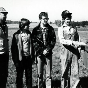 1970s_Land_Judging._Man_giving_award_to_group__2_Website-5034