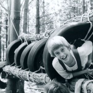 A_happy_6th_grader_completes_the_tire_tunnel_at_camp._Students_learn_trust_in_climbing_the_obstacle_course_website-2195