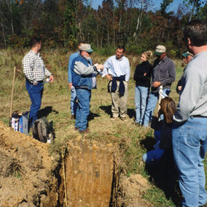 Land_Judging._Group_of_men___women_standing_around_hole_Website-5048