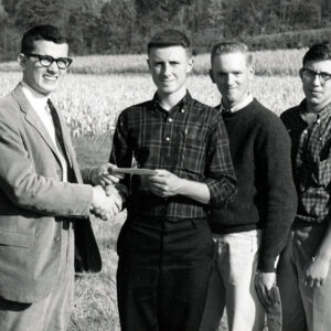 Land_Judging_unidentified_man_giving_award_to_3_young_people_Website-5042
