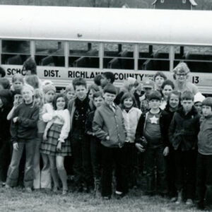 Large_gourp_of_boys_and_girls___1_adult_standing_in_front_of_Crestview_school_bus_on_a_farm_website-2826