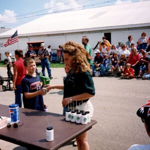 Two_young_people_at_sign_in_table._Spectators_in_background_website-2396